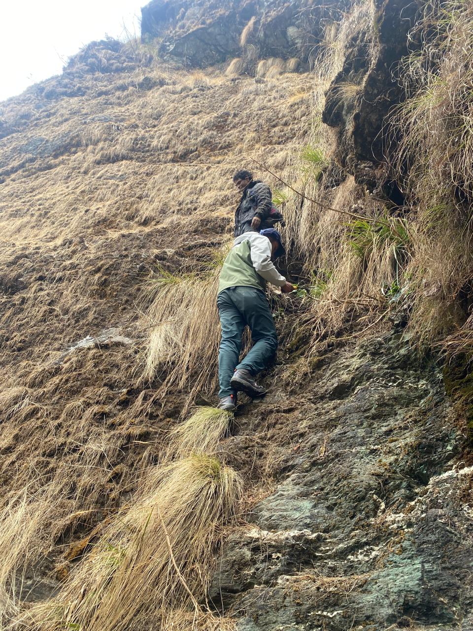 Field team climbing prospecting slope at Taman Khola, Baglung