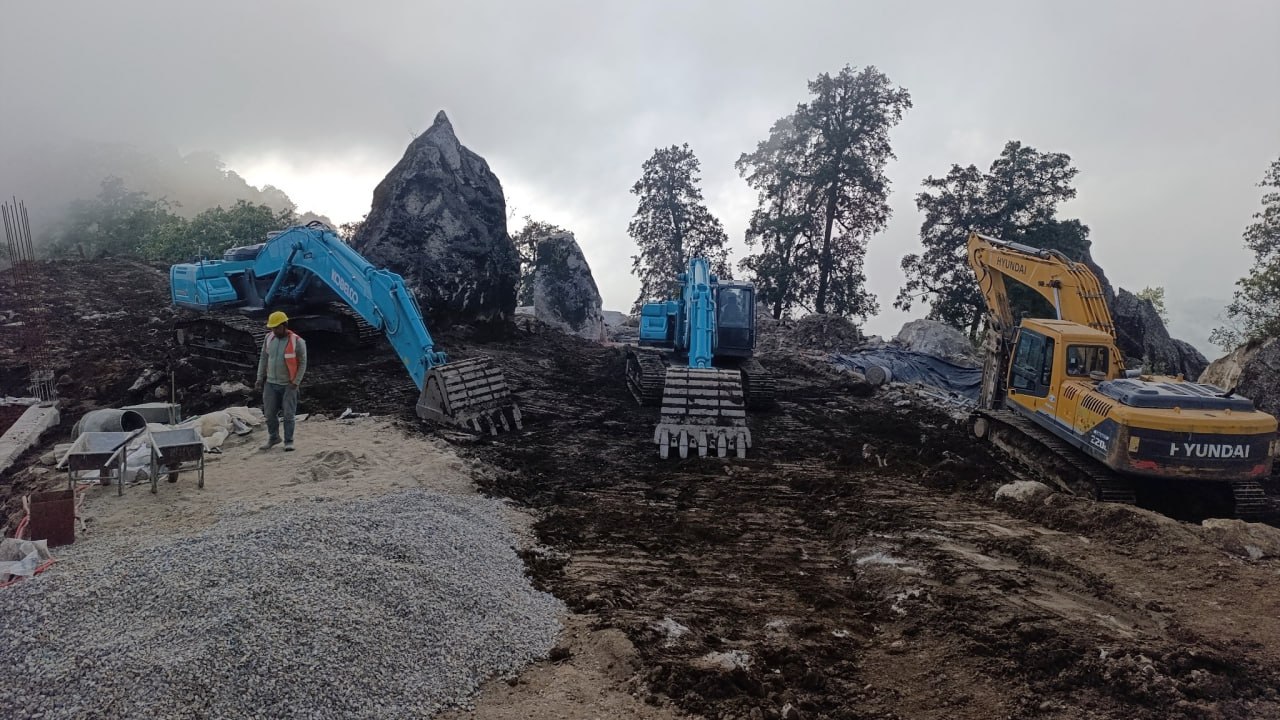 Kailash Granite Quarry operations with three excavators, a worker, granite formations and misty quarry environment