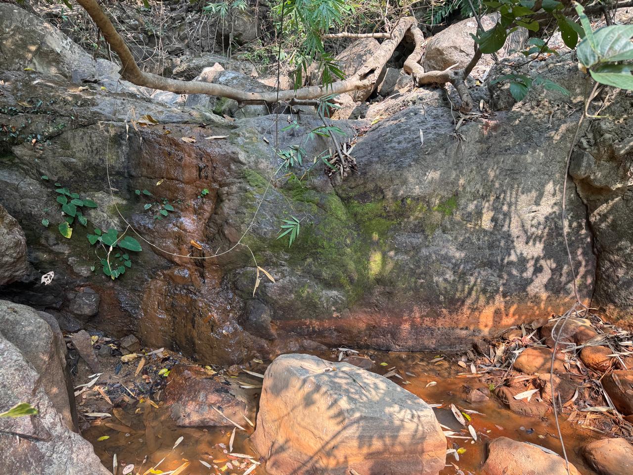 Mineral-stained water runoff near exposed rock in Bagmati, Makwanpur