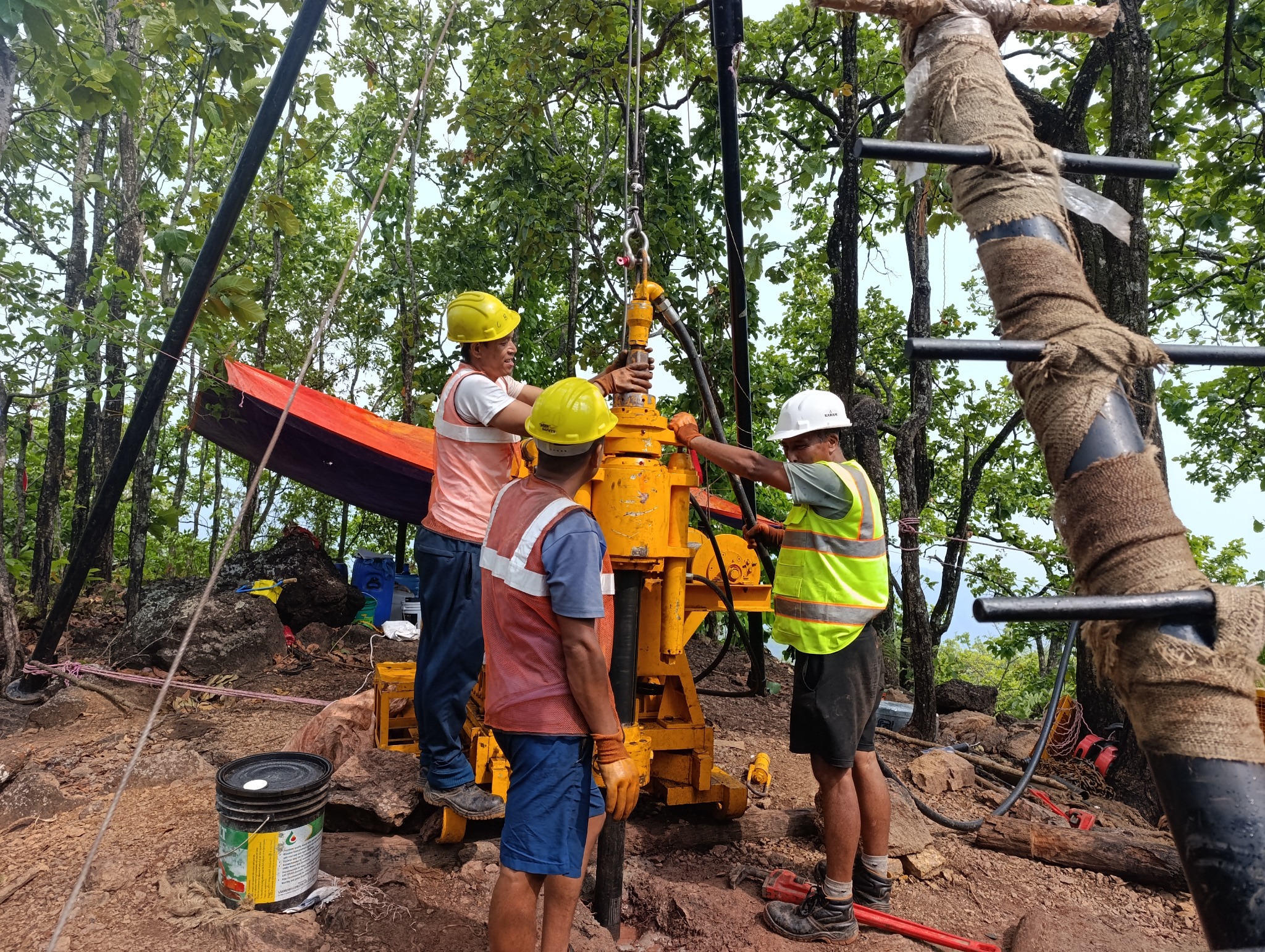 Field crew carrying out exploration drilling at Pharparbari