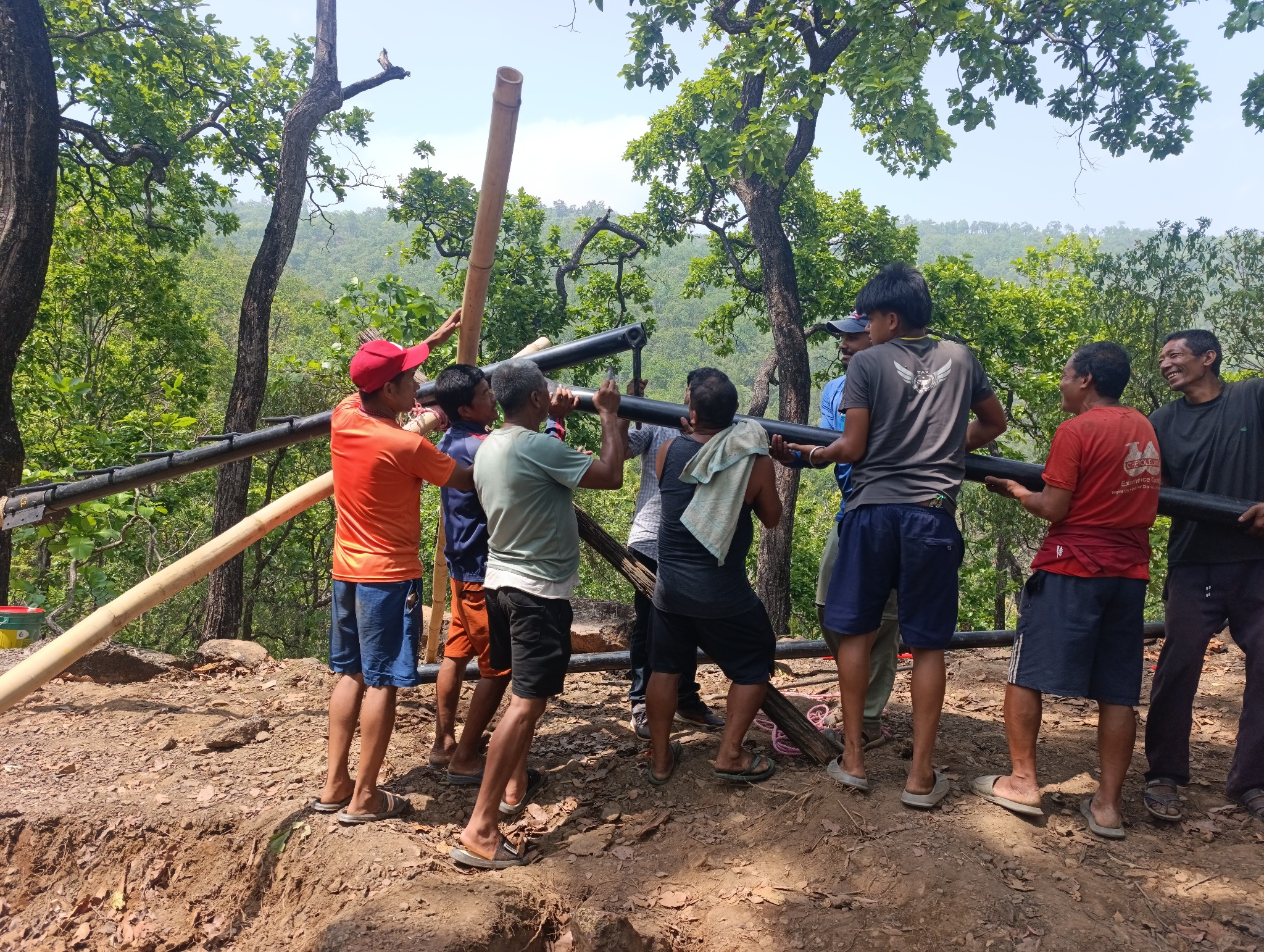 Field crew mobilising drilling equipment at Pharparbari